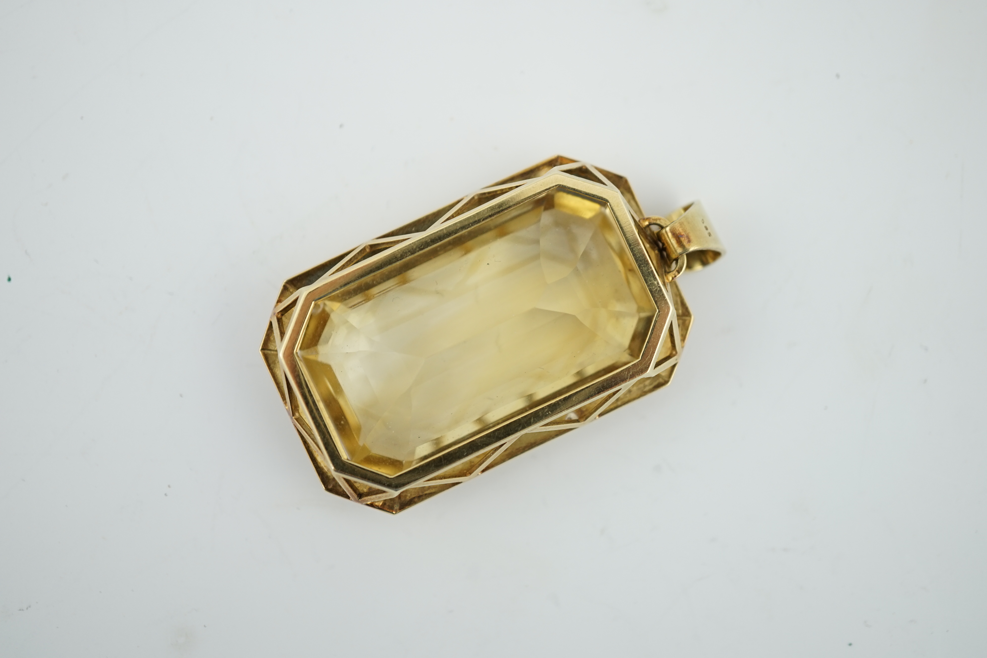 A large mid 20th century 14k gold and emerald cut citrine set pendant